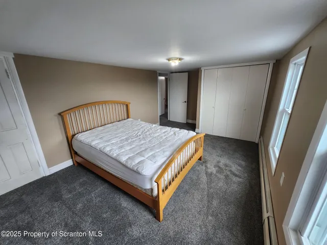 a bed sitting in a bedroom next to a window