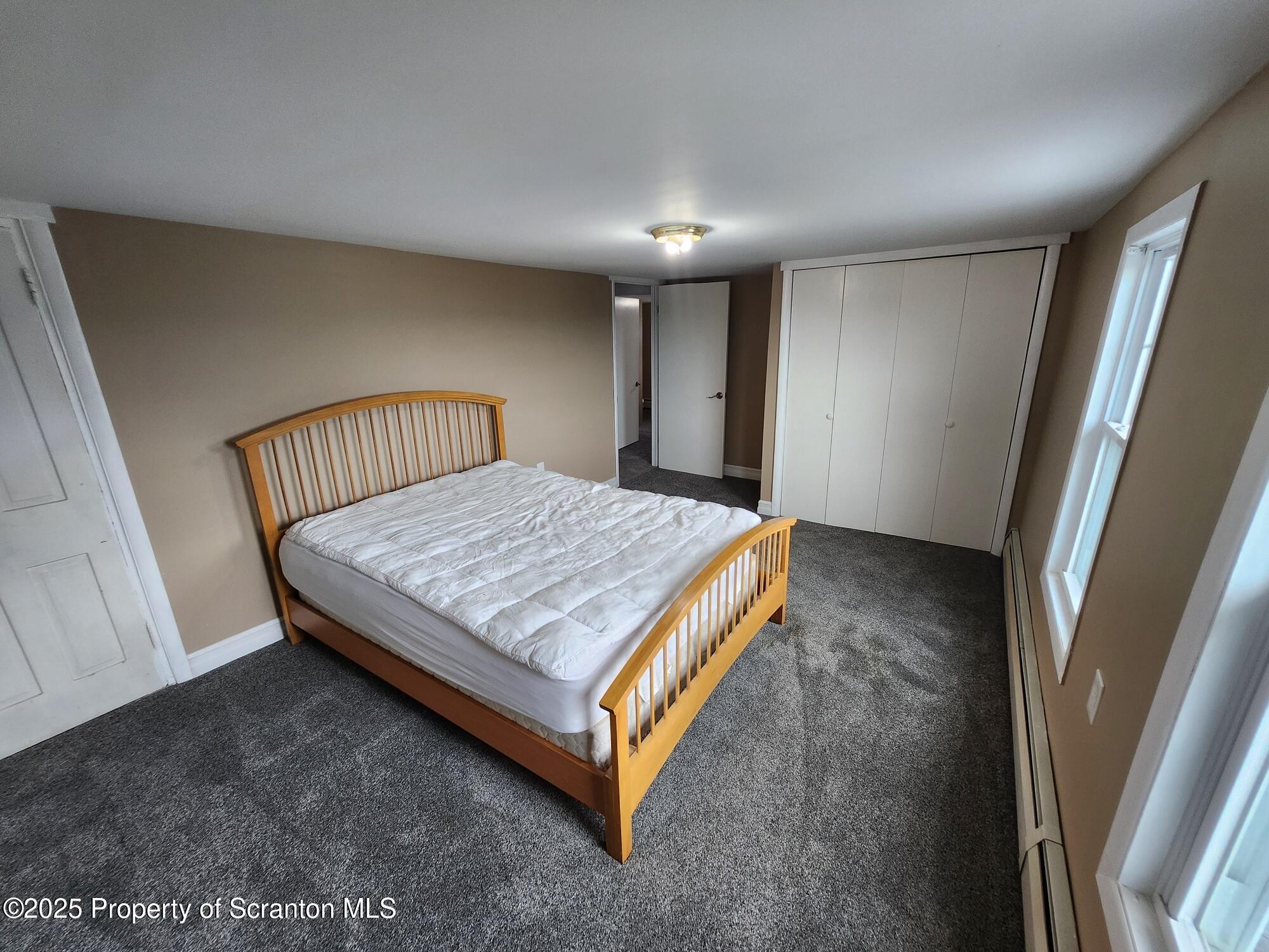 16 Flanagan Street Pringle, PA 18704 - Photo 25 of 33 a bed sitting in a room next to a window