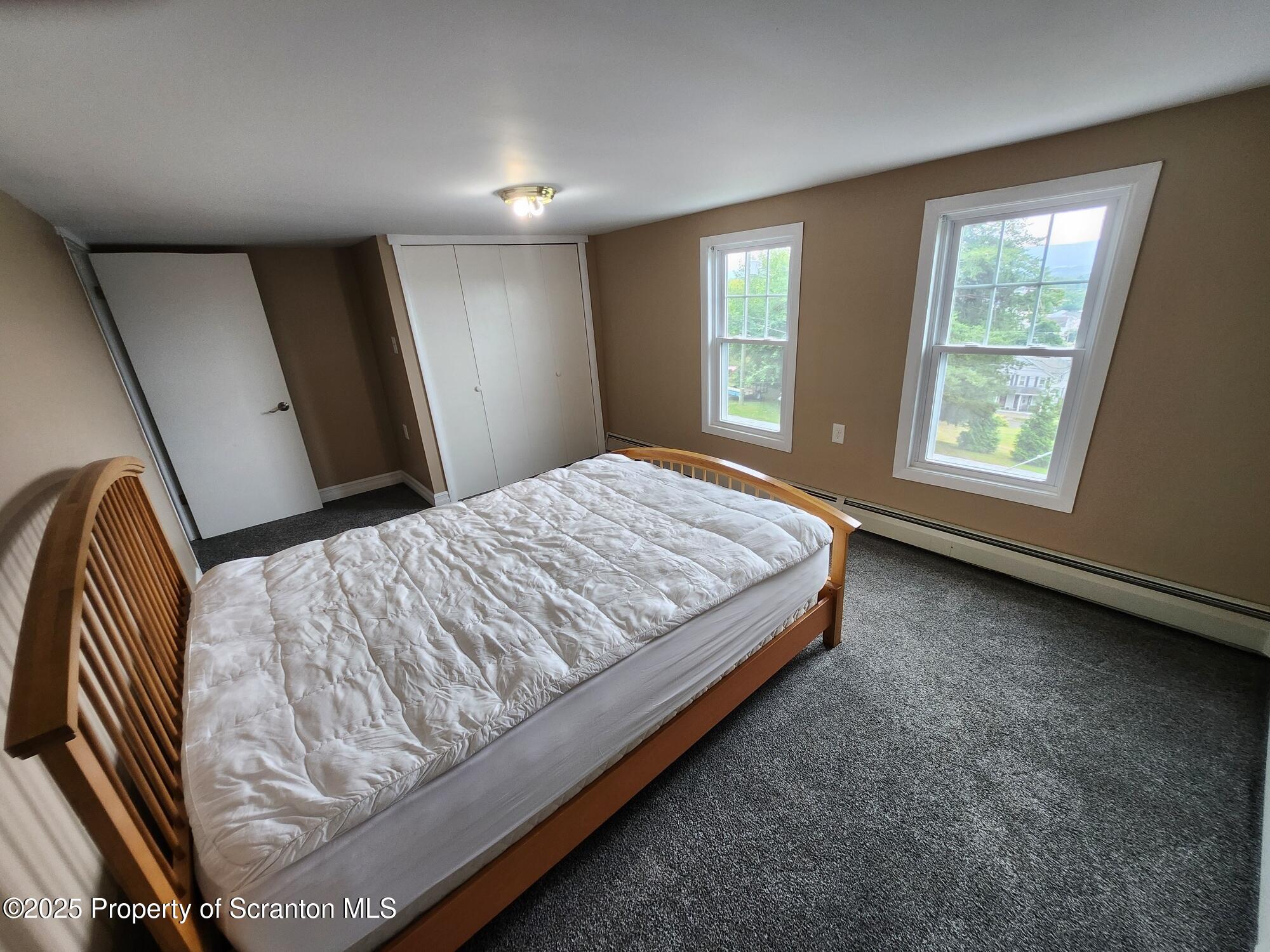 16 Flanagan Street Pringle, PA 18704 - Photo 26 of 33 a bed sitting in a bedroom next to a window