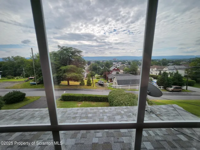 a bed sitting in a room next to a window