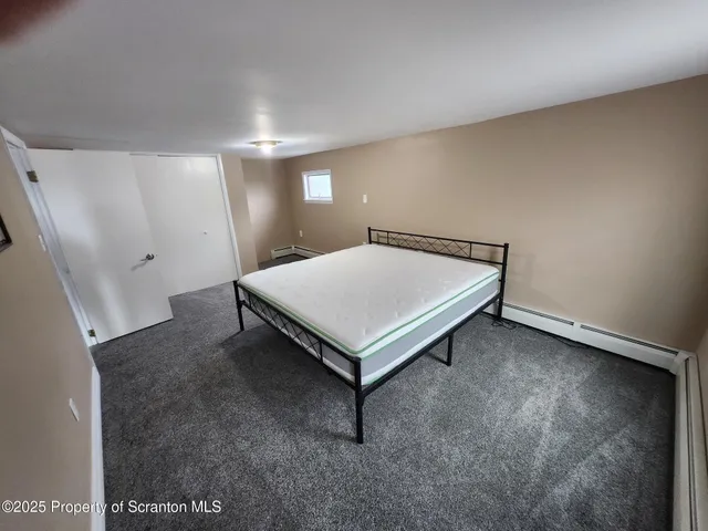 a bed room with a bed and mirror