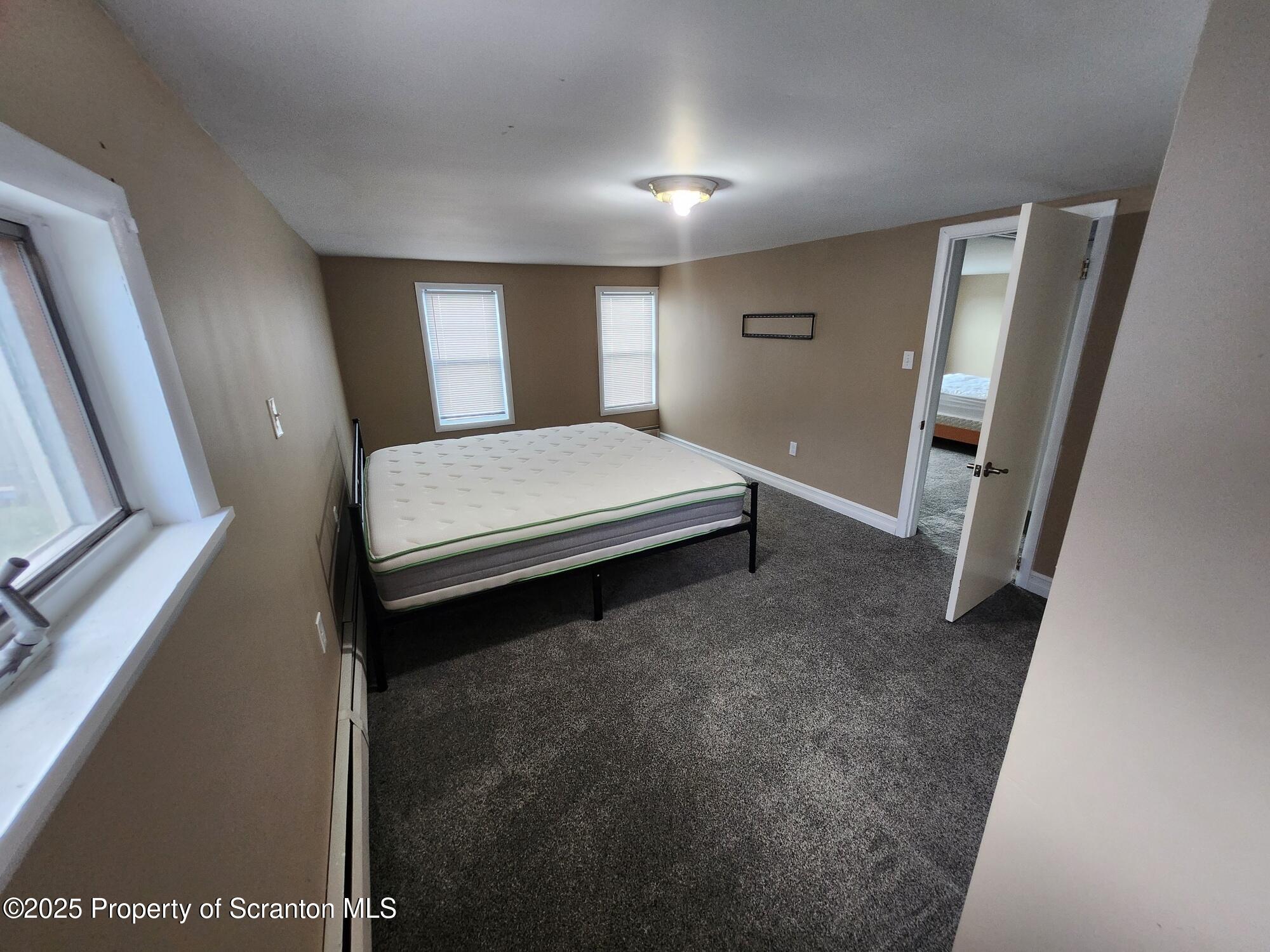 16 Flanagan Street Pringle, PA 18704 - Photo 30 of 33 a bed room with a bed and mirror