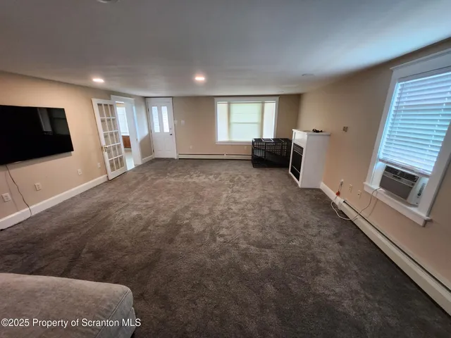 a view of a livingroom with furniture and a flat screen tv