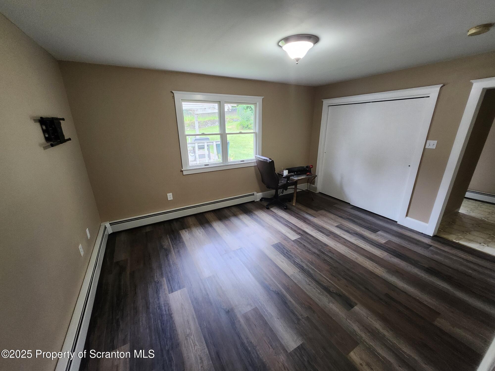 16 Flanagan Street Pringle, PA 18704 - Photo 10 of 33 an empty room with wooden floor and windows