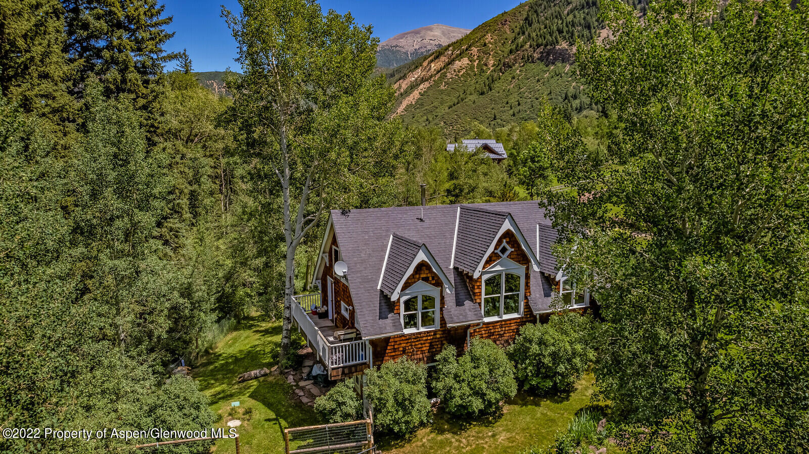 800 Dorais Way Redstone, CO 81623 - Photo 3 of 35 an aerial view of a house with yard and trees in the background