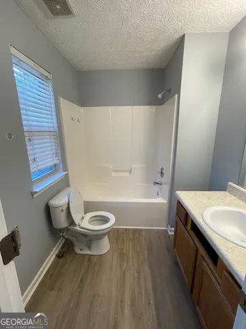a bathroom with a toilet a sink and bathtub