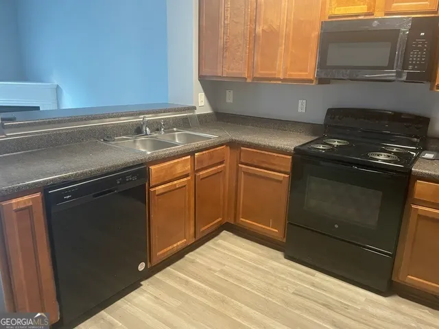 a kitchen with granite countertop a stove and a sink