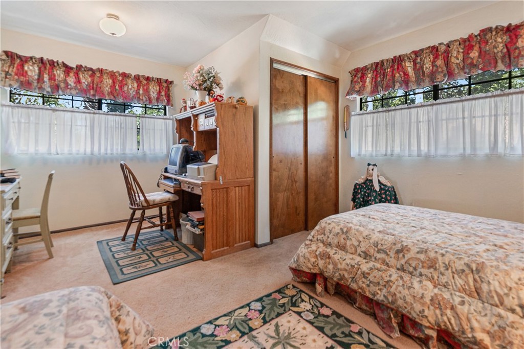 329 Grass Valley Road Lake Arrowhead, CA 92352 - Photo 16 of 31 a bedroom with a bed a desk and chair with the wooden floor