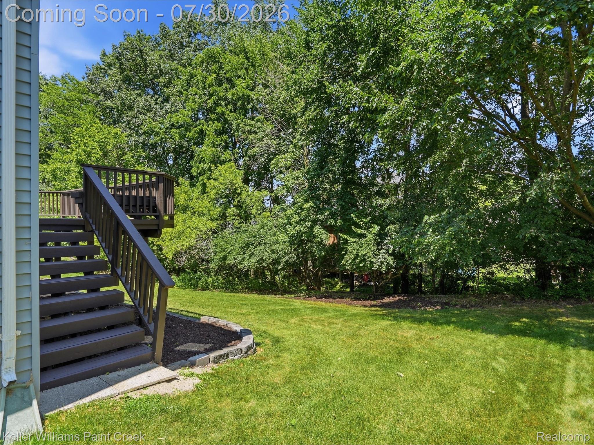 543 Arlington Drive Rochester, MI 48307 - Photo 46 of 59 Expansive green lawn with mature trees and a multi-level wood deck