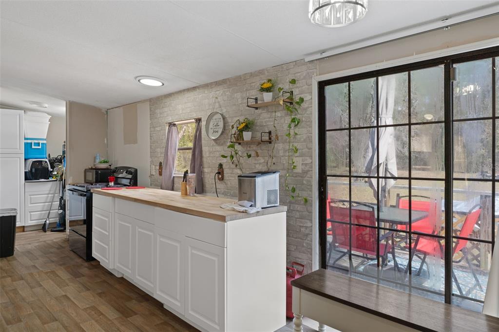 11881 Southwest 45th Street Webster, FL 33597 - Photo 11 of 27 a large white kitchen with a large window