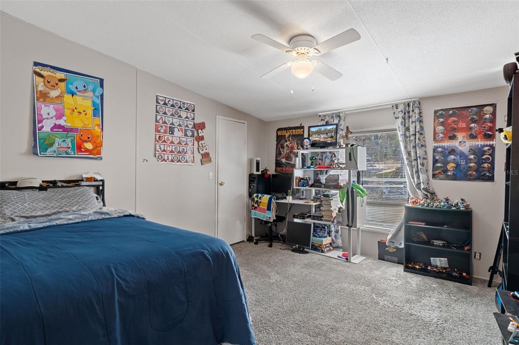 11881 Southwest 45th Street Webster, FL 33597 - Photo 13 of 27 a bedroom with furniture and a bed