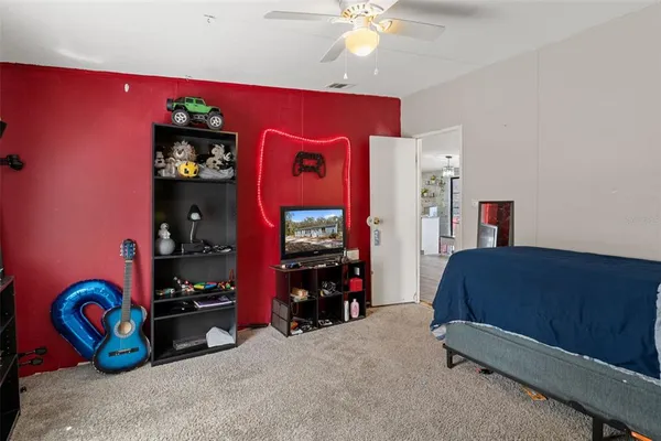 a bedroom with bed and a chandelier