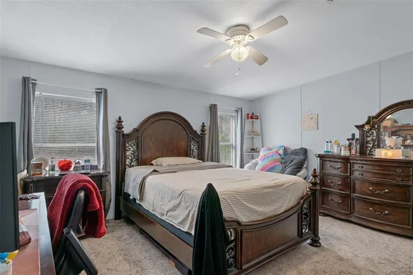 a bedroom with a bed and a dresser