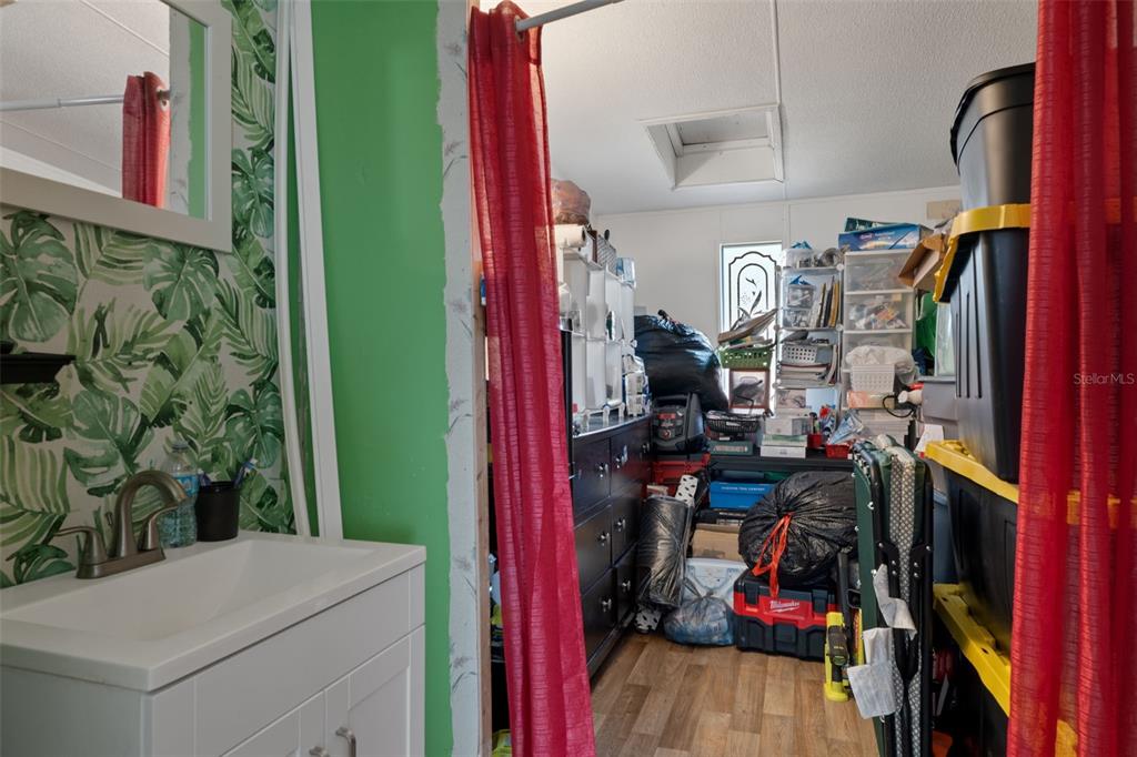 11881 Southwest 45th Street Webster, FL 33597 - Photo 19 of 27 a view of walk in closet with clothes