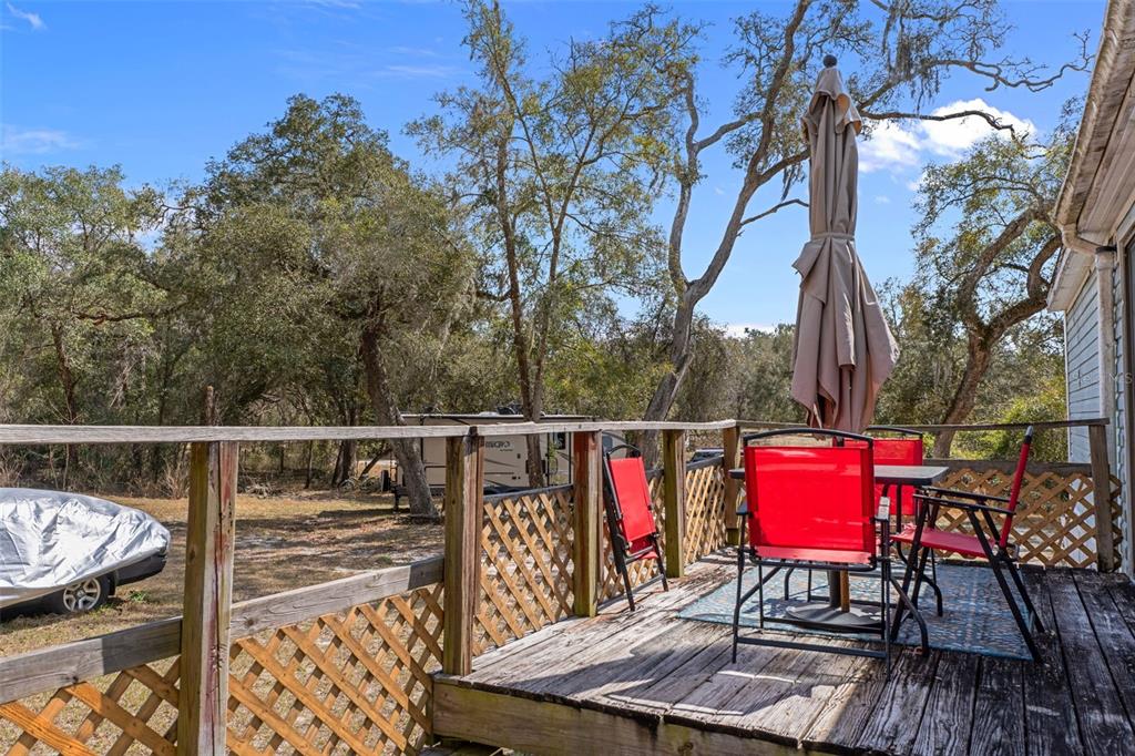 11881 Southwest 45th Street Webster, FL 33597 - Photo 20 of 27 a view of balcony with seating space and trees