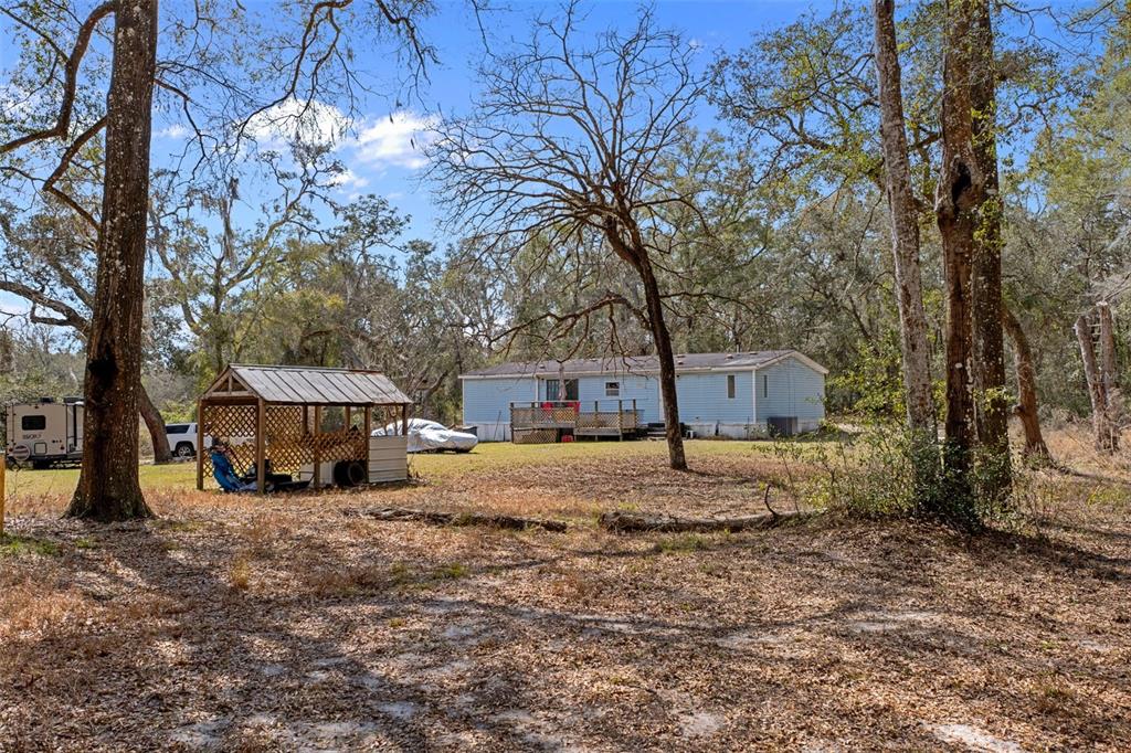 11881 Southwest 45th Street Webster, FL 33597 - Photo 21 of 27 a house that has a tree in front of it