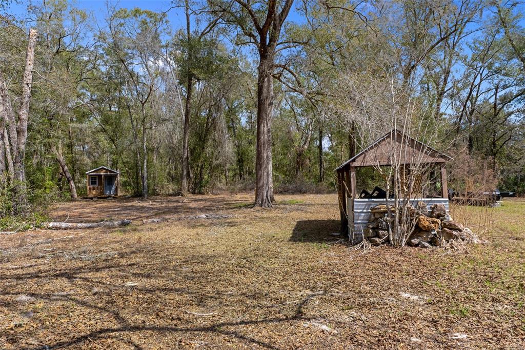 11881 Southwest 45th Street Webster, FL 33597 - Photo 23 of 27 a backyard of a house with table and chairs