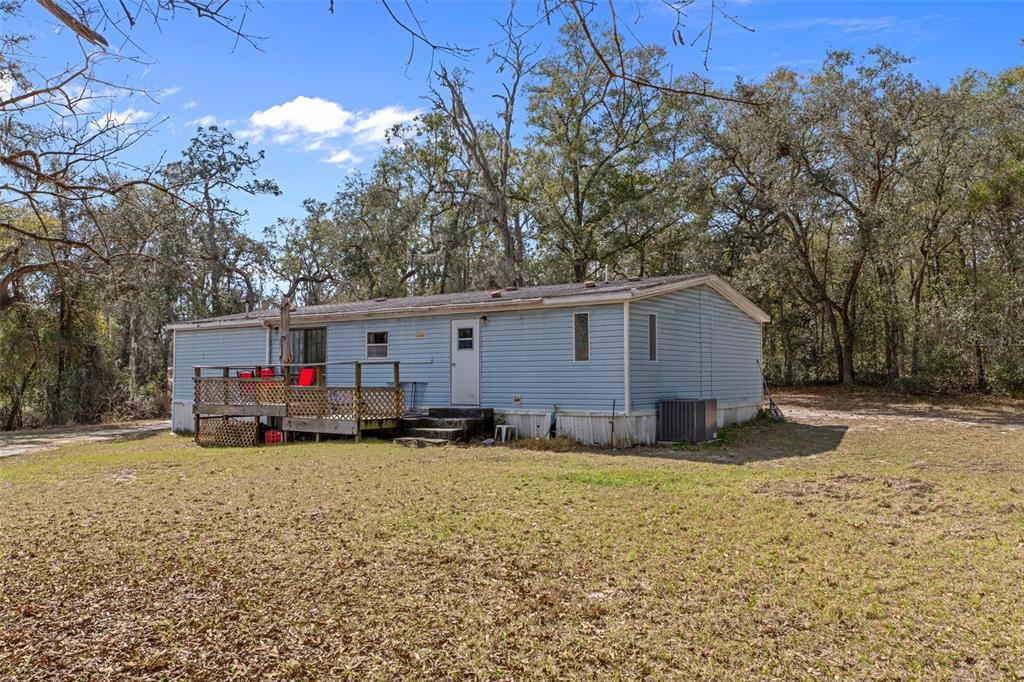 11881 Southwest 45th Street Webster, FL 33597 - Photo 24 of 27 a view of a house with a yard