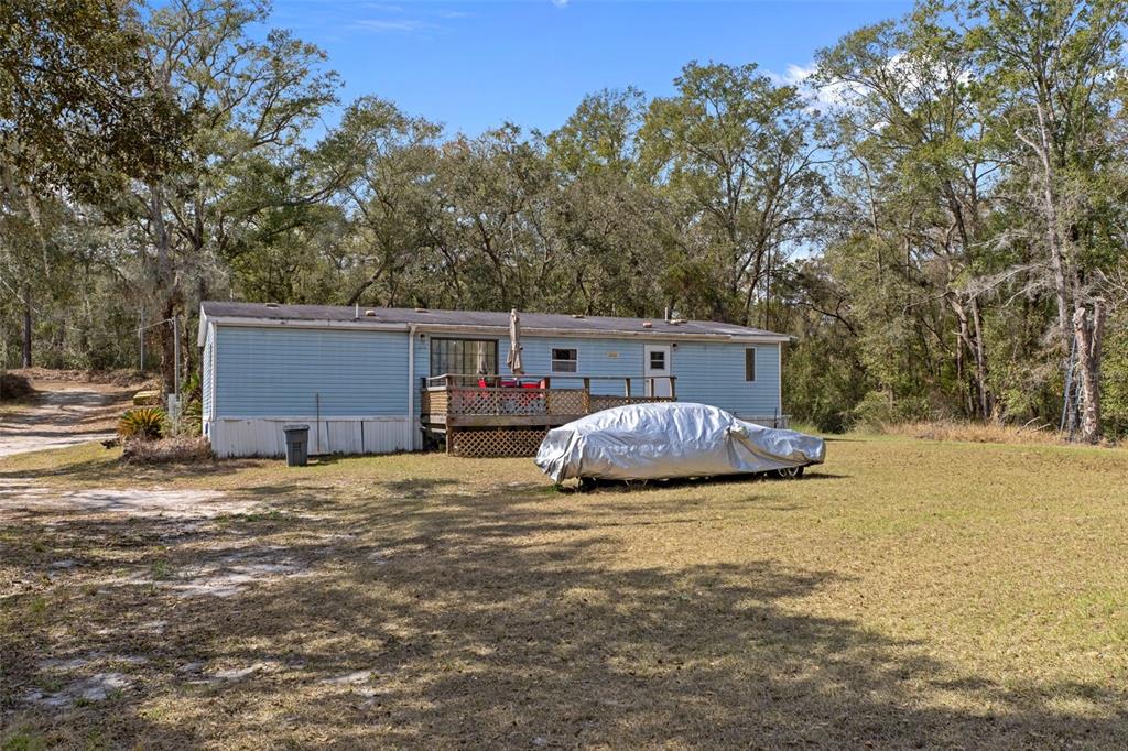 11881 Southwest 45th Street Webster, FL 33597 - Photo 27 of 27 a view of a house with a yard and garage