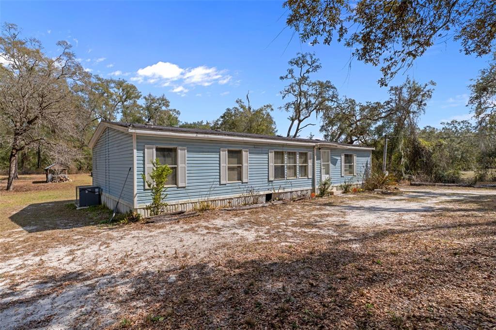11881 Southwest 45th Street Webster, FL 33597 - Photo 6 of 27 a view of a house with a large tree in a yard