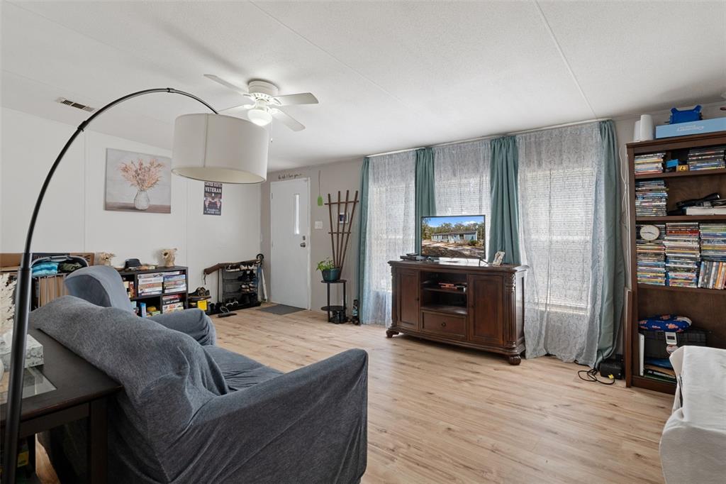 11881 Southwest 45th Street Webster, FL 33597 - Photo 8 of 27 a living room with furniture and wooden floor
