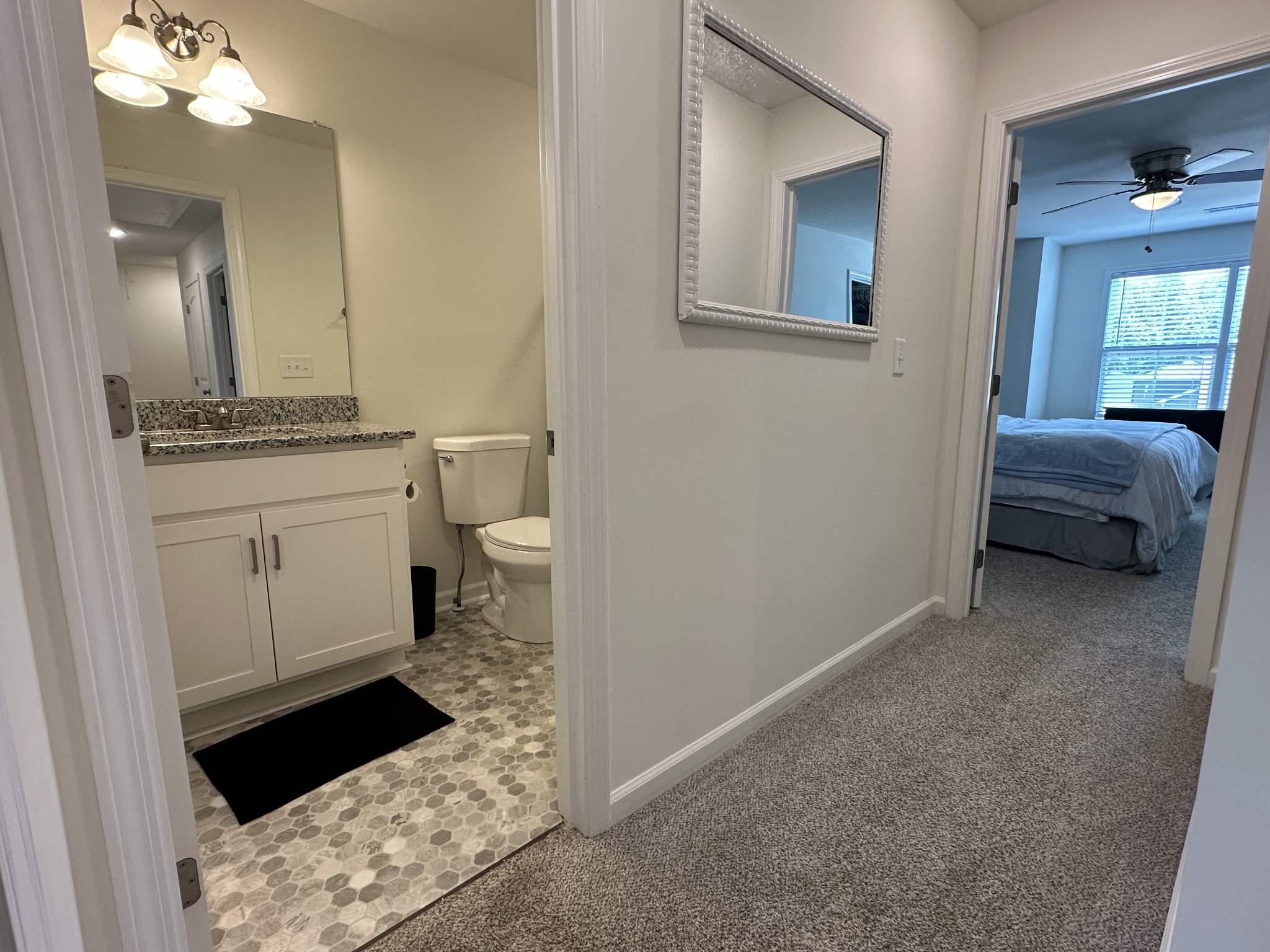 128 Quarry Rdg Road Clarksville, TN 37043 - Photo 14 of 24 a bathroom with a granite countertop sink a toilet and a mirror