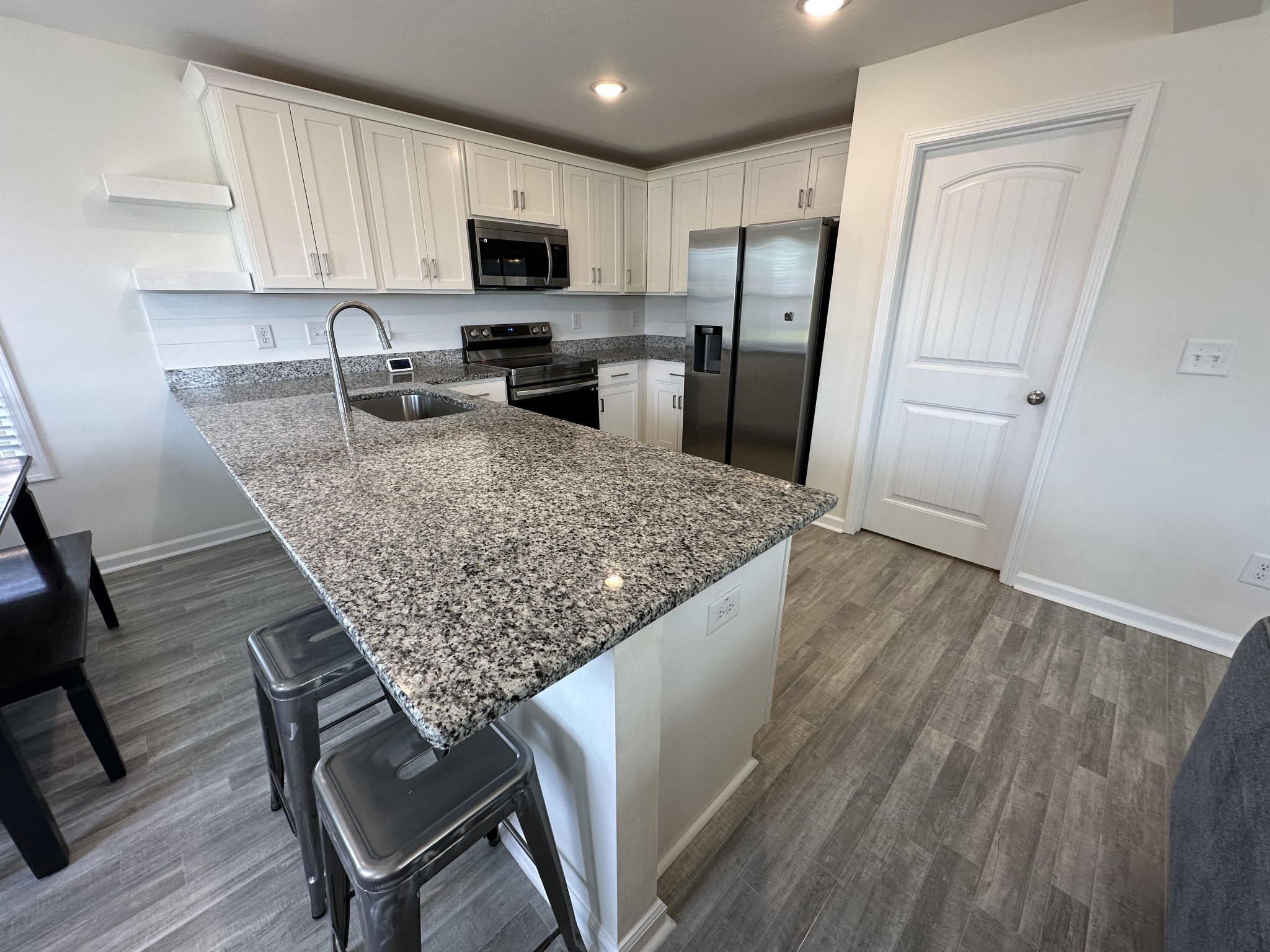 128 Quarry Rdg Road Clarksville, TN 37043 - Photo 6 of 24 a kitchen with stainless steel appliances granite countertop a refrigerator sink microwave and cabinets