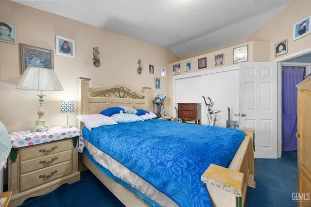 a bed room with a bed and a chair