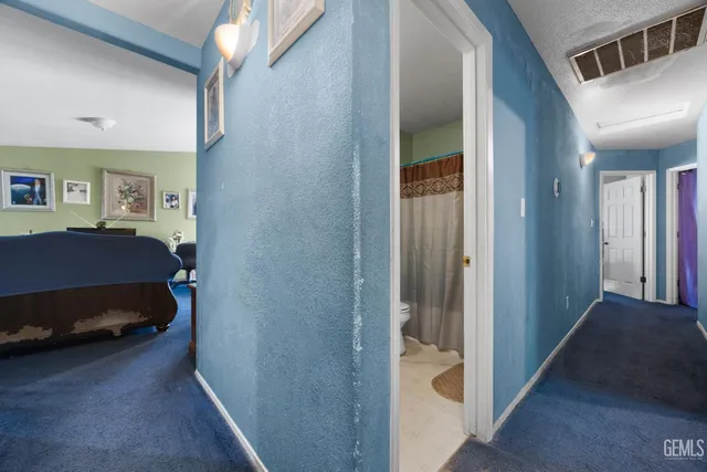 a bedroom with a bed and a mirror