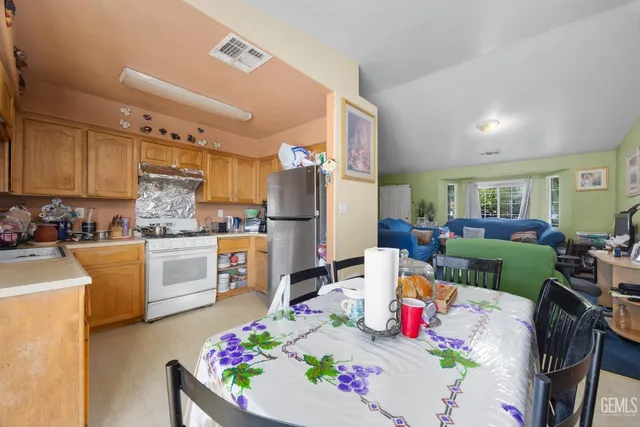 a living room with furniture and kitchen view
