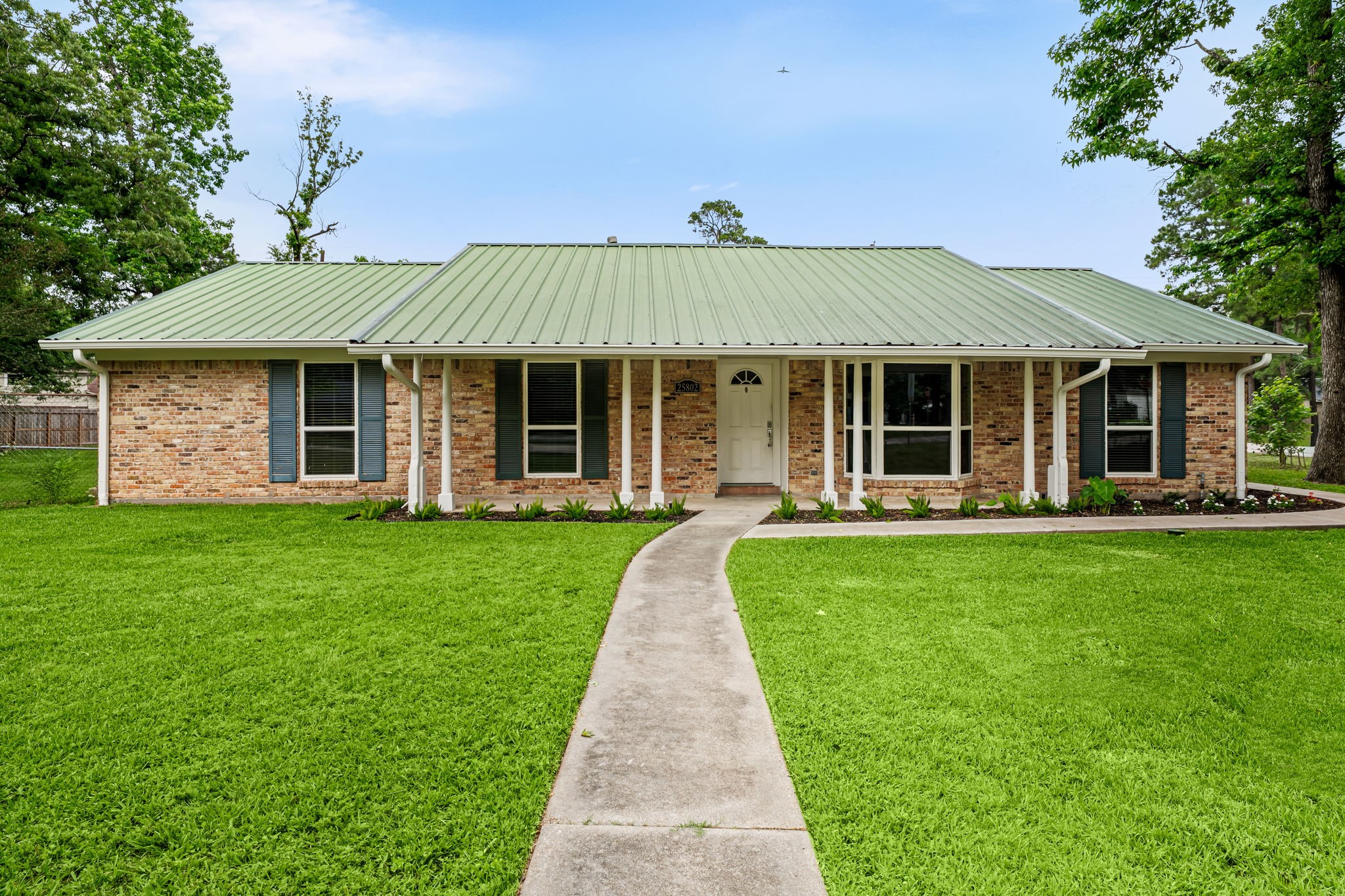 a front view of a house with a garden