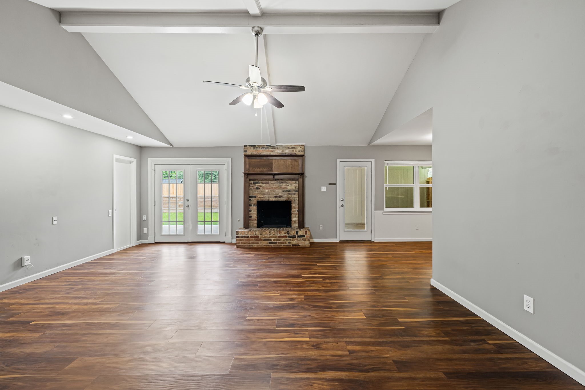 25802 Maplewood Drive Spring, TX 77386 - Photo 13 of 32 a view of an empty room with wooden floor fireplace and a window