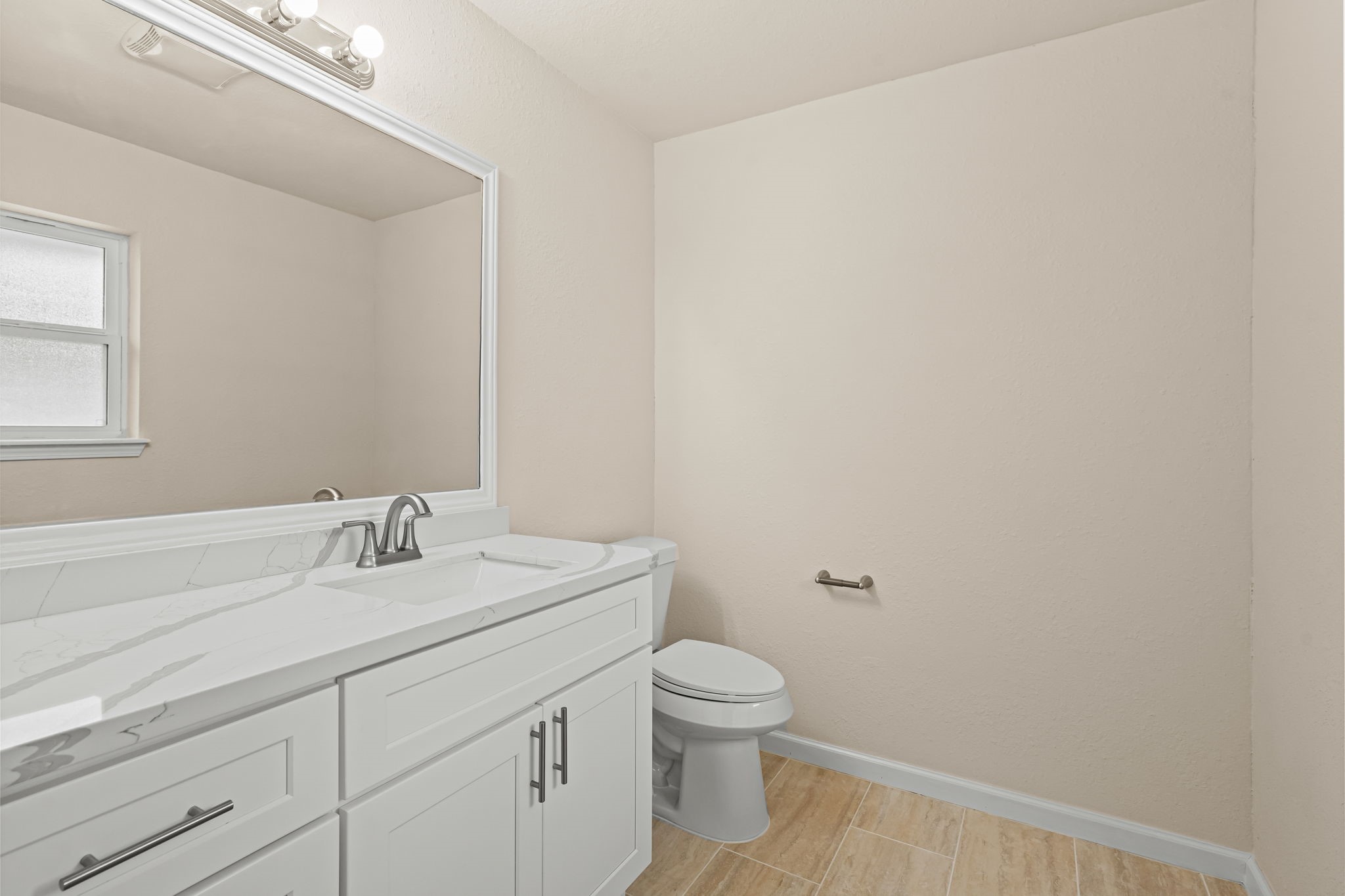 25802 Maplewood Drive Spring, TX 77386 - Photo 19 of 32 a bathroom with a toilet a sink and mirror