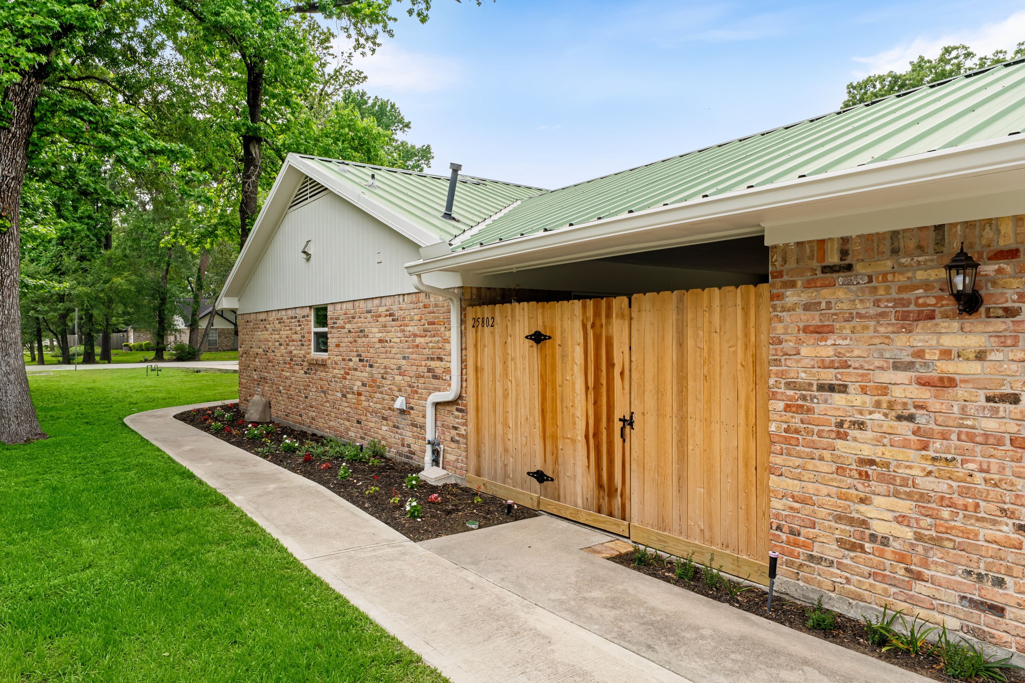 25802 Maplewood Drive Spring, TX 77386 - Photo 27 of 32 a front view of a house with garden