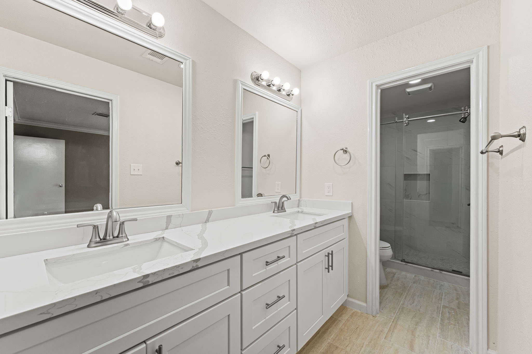 25802 Maplewood Drive Spring, TX 77386 - Photo 3 of 32 a spacious bathroom with double sink a a mirror a shower and vanity