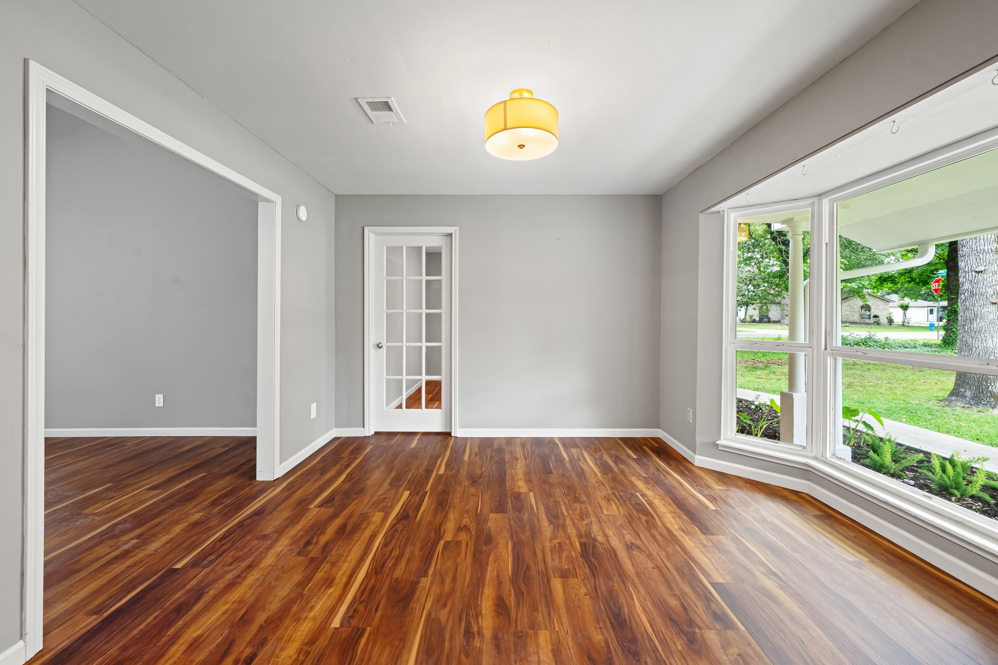 25802 Maplewood Drive Spring, TX 77386 - Photo 10 of 32 a view of an empty room with wooden floor and a window