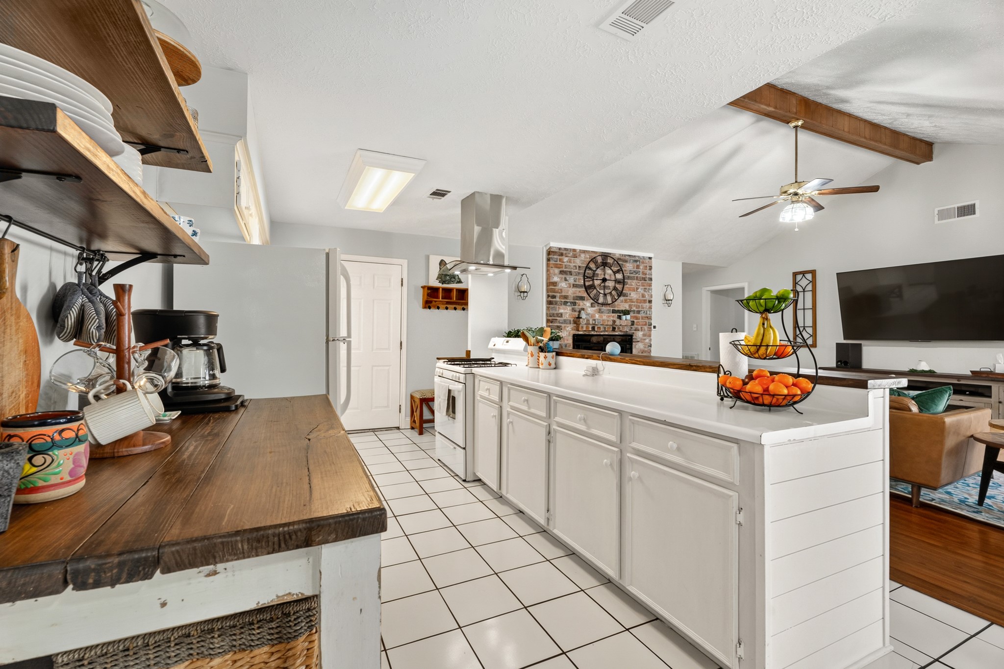 2104 Rose Road Pearland, TX 77581 - Photo 25 of 43 a kitchen with sink a stove and cabinets