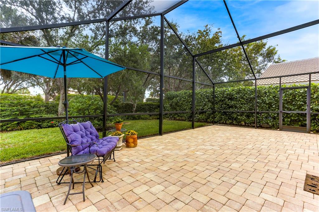 a view of backyard with furniture and umbrella