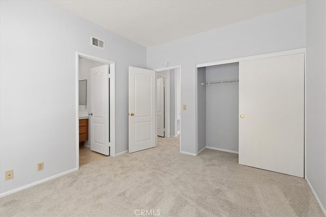 a view of a grassy field with mountains in the background
