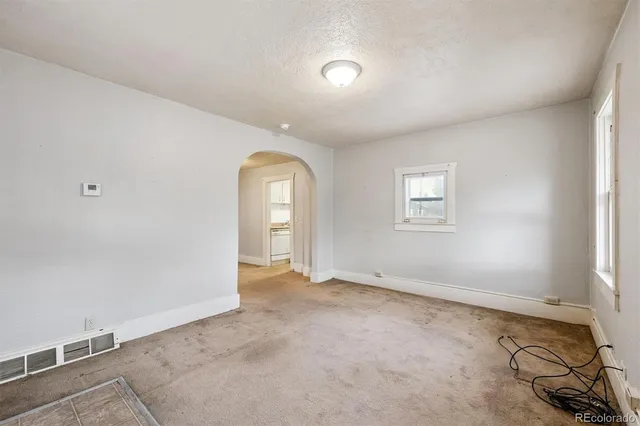 an empty room with windows and closet