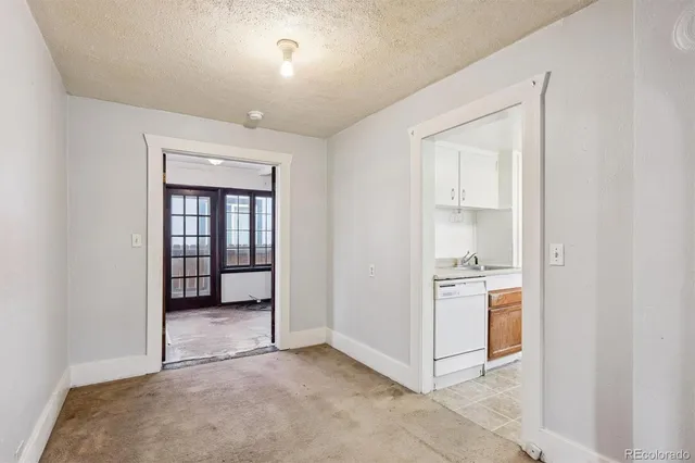 a white refrigerator freezer and a stove sitting inside of a kitchen