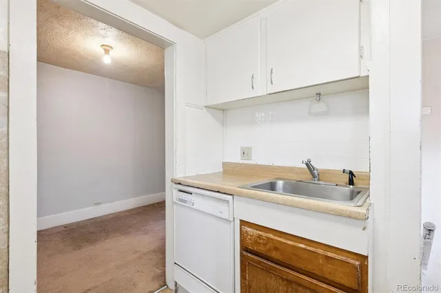 a bathroom with a sink a window and shower