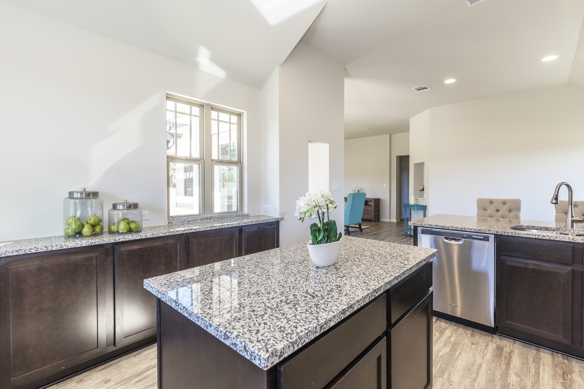 2725 Hopi Path Leander, TX 78641 - Photo 22 of 30 A well-lit kitchen with granite countertops and rich cabinetry offers both style and utility.