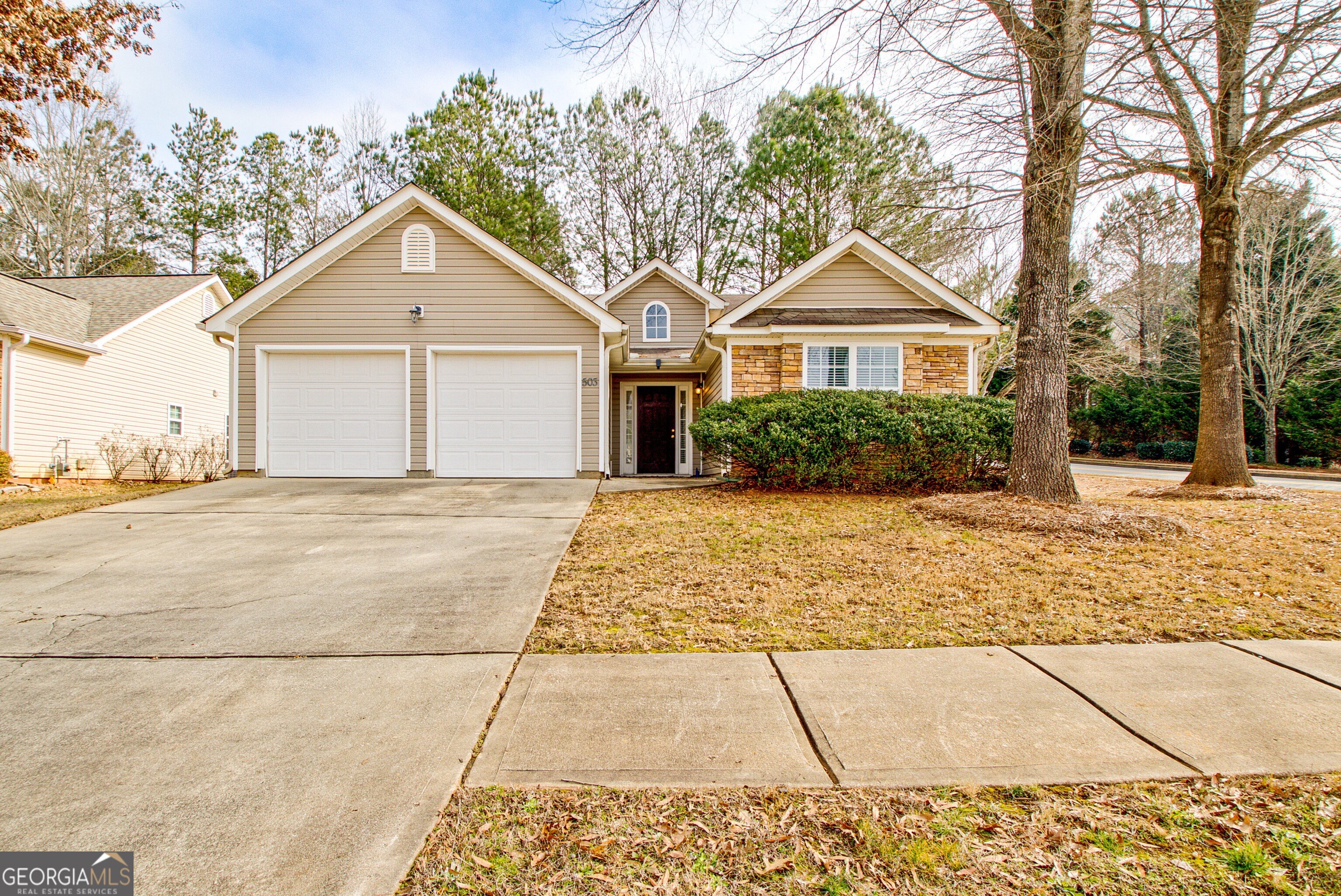 503 Hunterian Place Newnan, GA 30265 - Photo 1 of 28 a front view of a house with a yard and trees