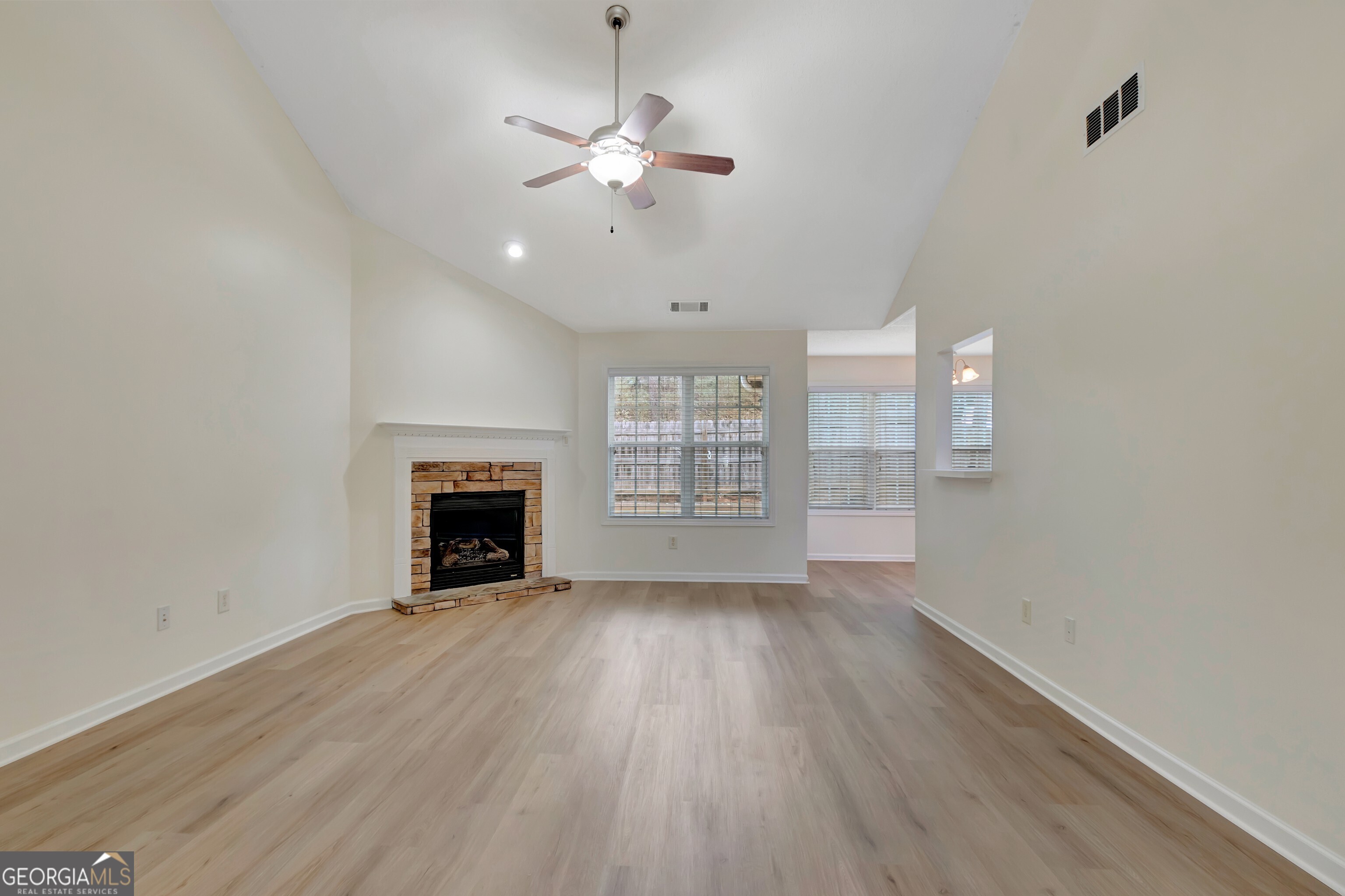 503 Hunterian Place Newnan, GA 30265 - Photo 11 of 28 a view of an empty room with wooden floor fireplace and a window