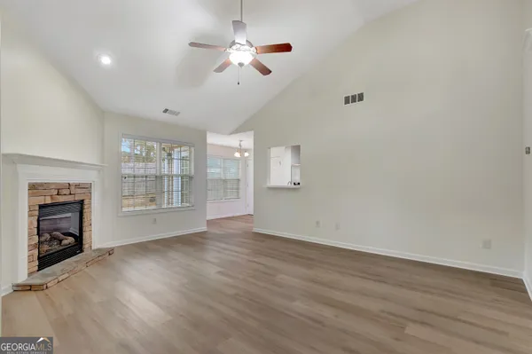 wooden floor in an empty room with a fireplace
