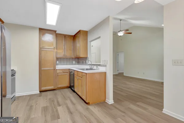 a kitchen with a refrigerator and cabinets