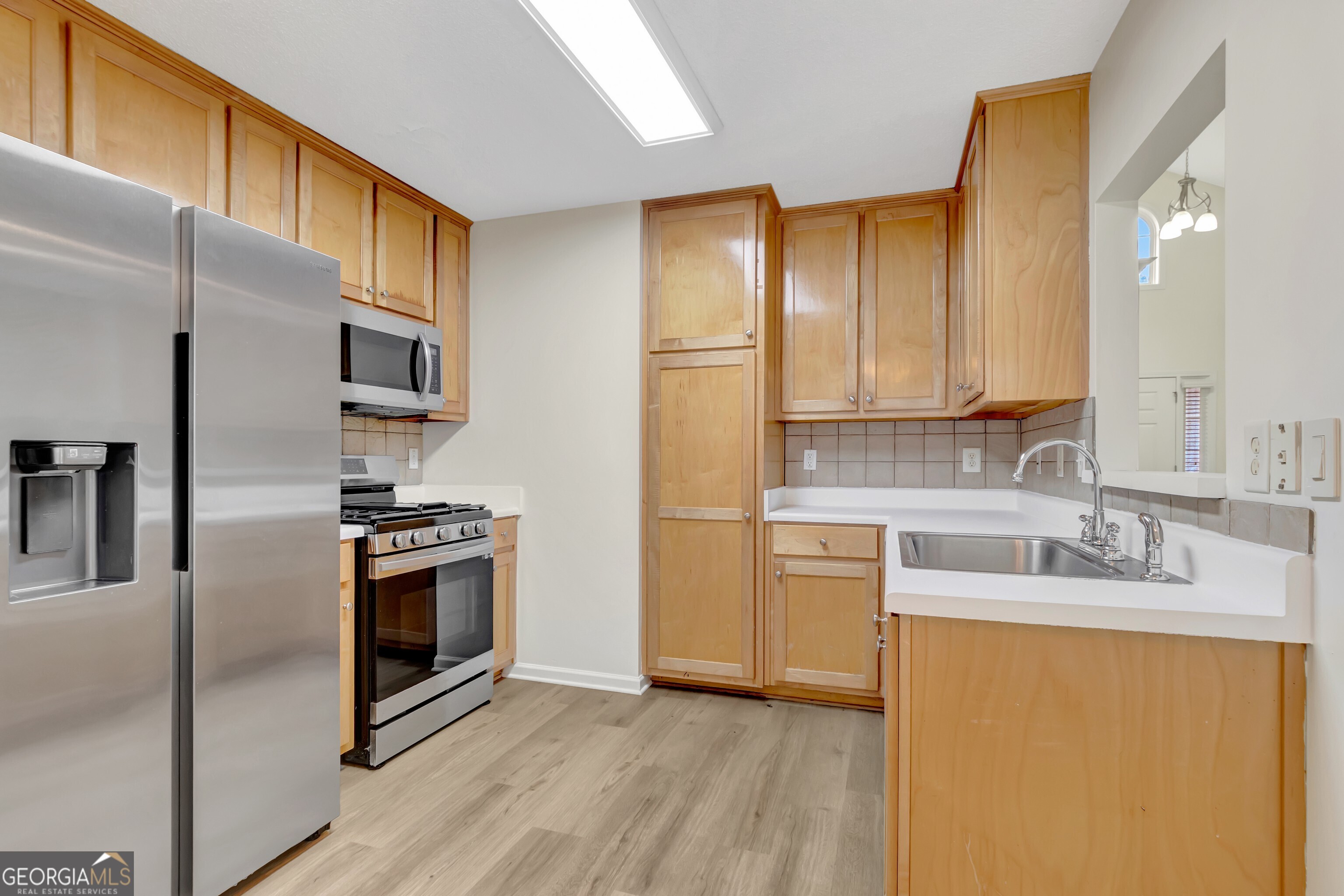 503 Hunterian Place Newnan, GA 30265 - Photo 16 of 28 a kitchen with stainless steel appliances granite countertop a refrigerator a stove a sink and a microwave