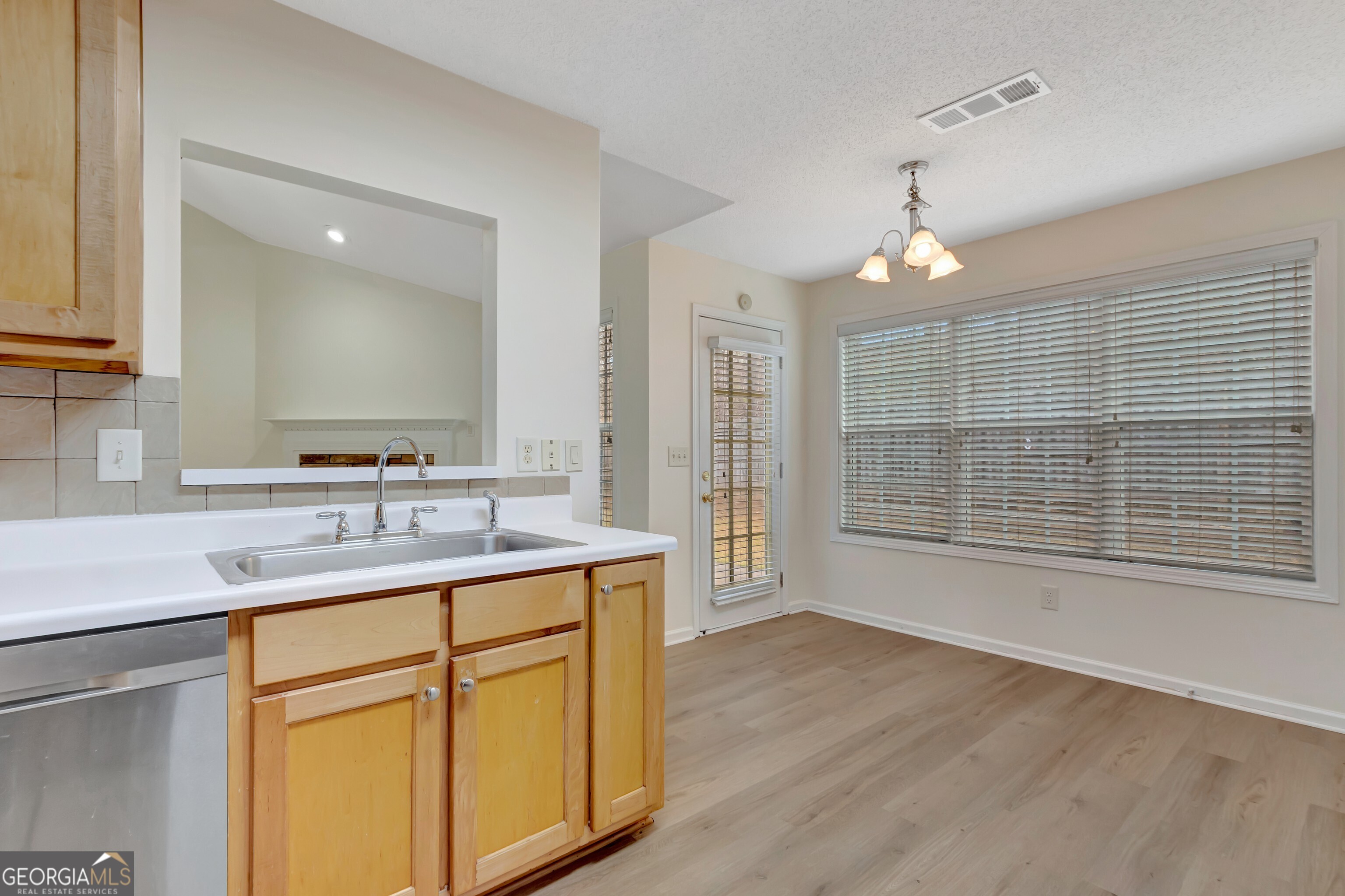 503 Hunterian Place Newnan, GA 30265 - Photo 17 of 28 a bathroom with a double vanity sink a mirror and a shower