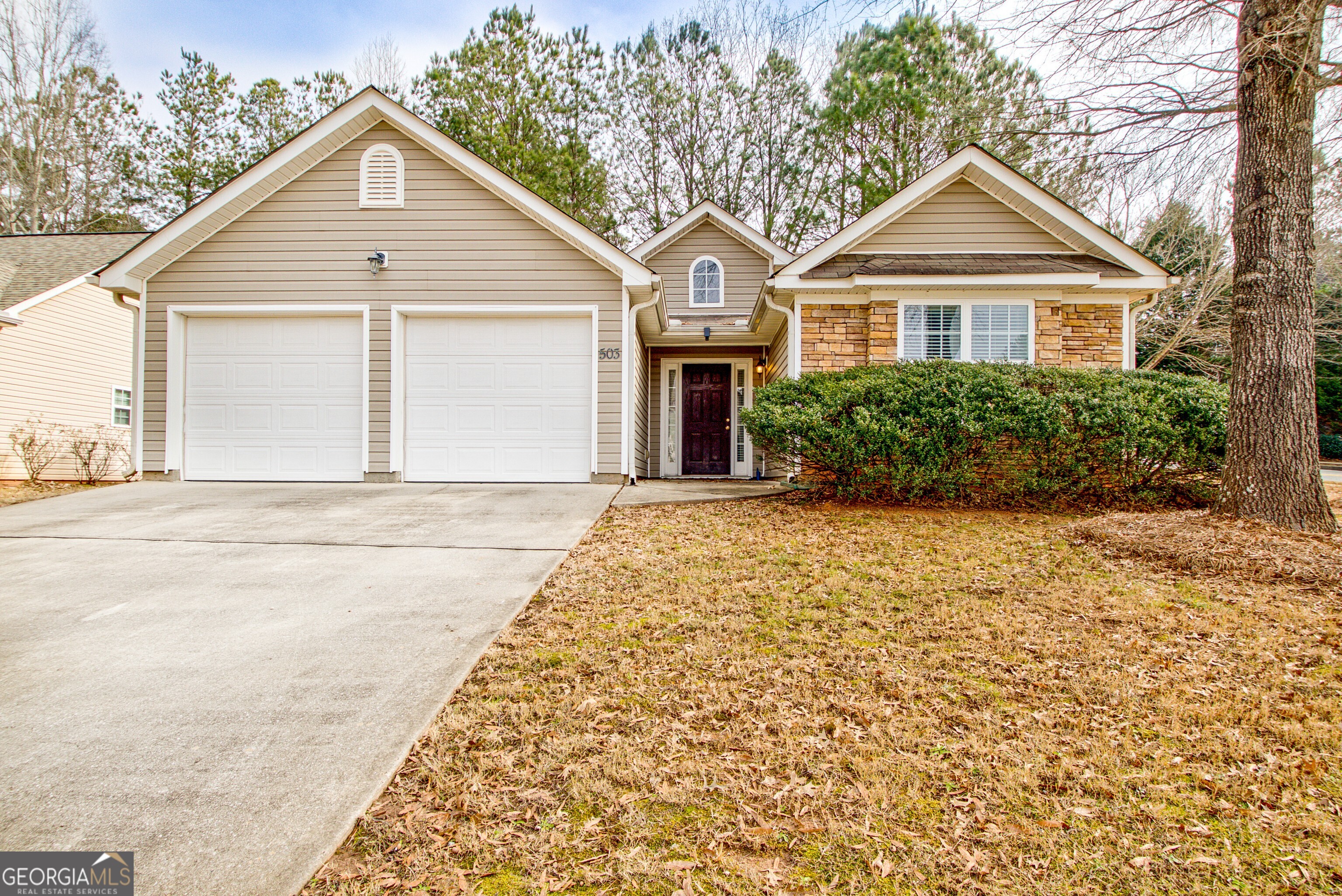 503 Hunterian Place Newnan, GA 30265 - Photo 2 of 28 a front view of a house with a garden